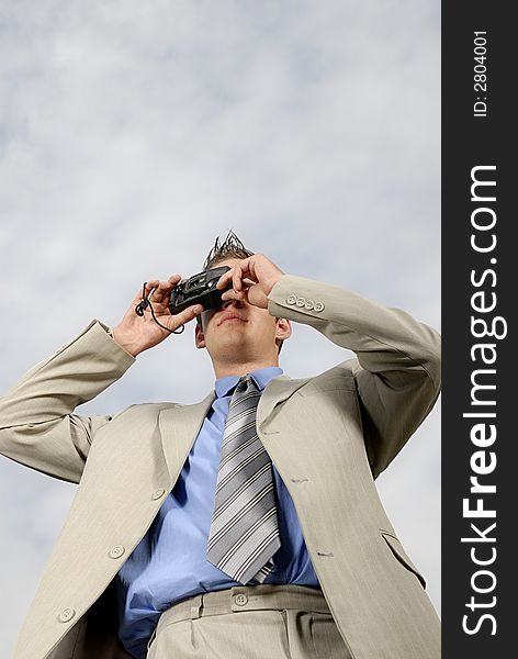 Young businessman with camera in his hands taking picture