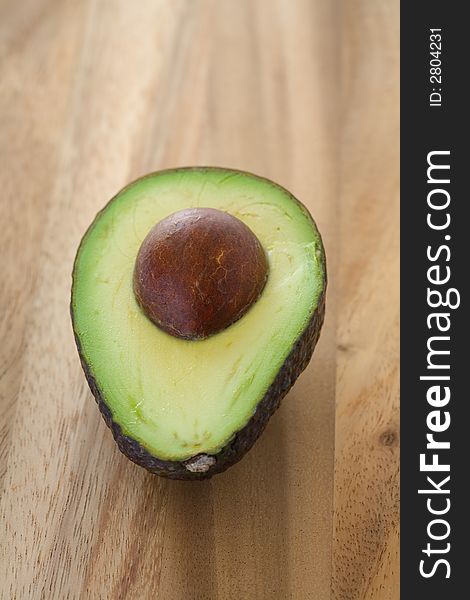 Avocado split in two on a wooden table