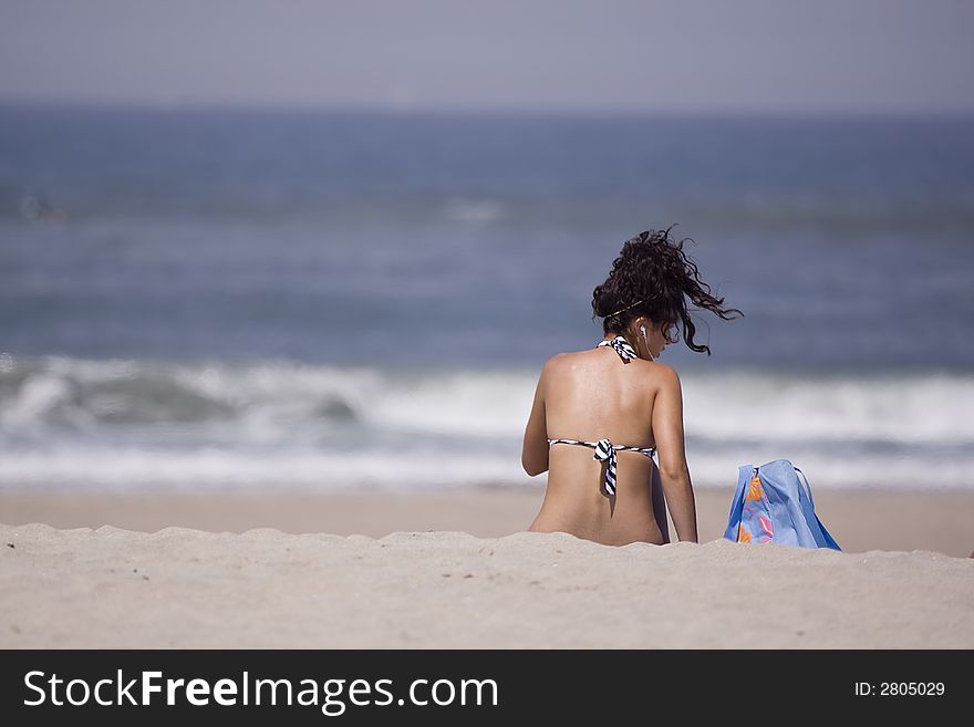 Girl seated in the beach. Girl seated in the beach