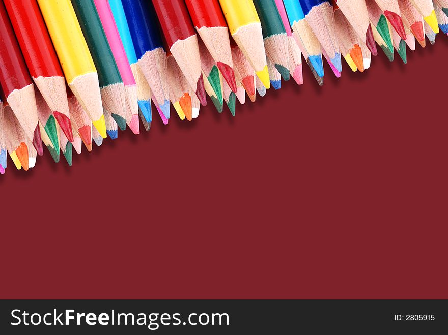 Color pencils frame on brown background
