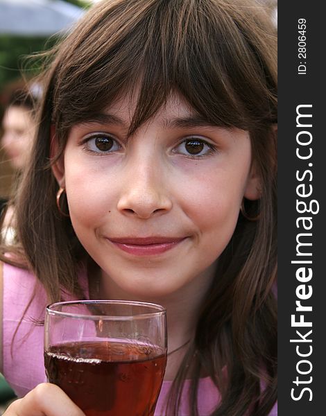 Beautiful young girl preparing to drink a cooling glass of juice. Beautiful young girl preparing to drink a cooling glass of juice