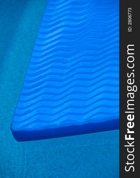Close up of blue floatie in a blue pool. Close up of blue floatie in a blue pool