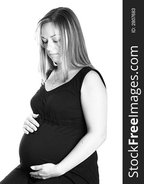 A very beautiful pregnant woman holding her tummy. A very beautiful pregnant woman holding her tummy.