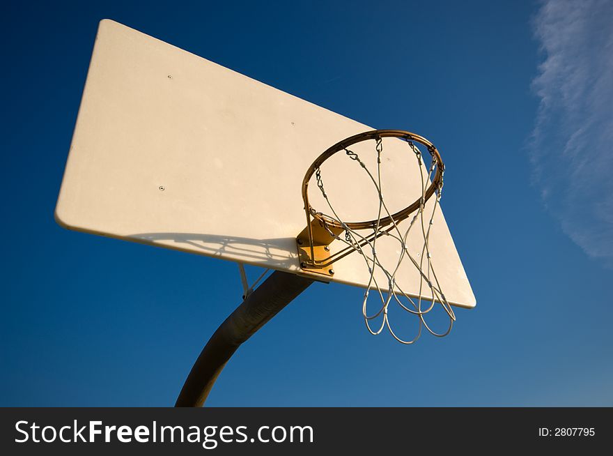 Basketball hoop and net with blue sky background. Basketball hoop and net with blue sky background