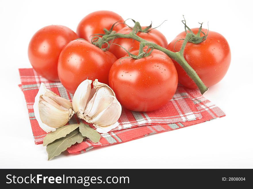 Tomatoes, garlic, bay leaf on white background