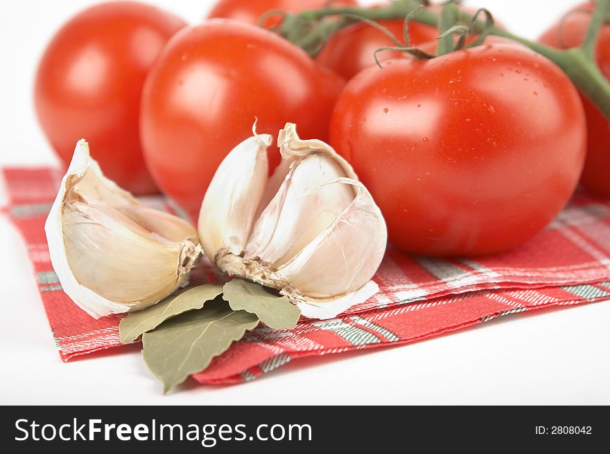 Tomato, garlic, bay leaf on white background