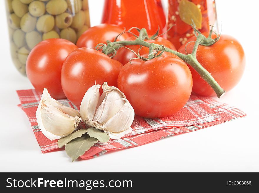 Tomatoes, garlic, bay leaf on white background