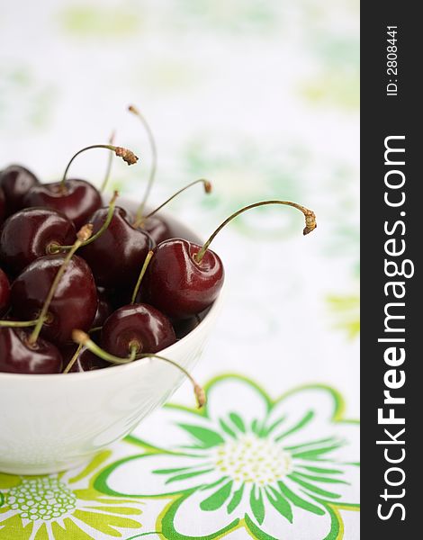 Fresh cherries on white bowl, shallow focus
