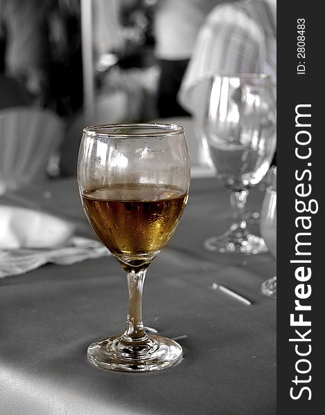 A amber glass of champaign on a black and white background