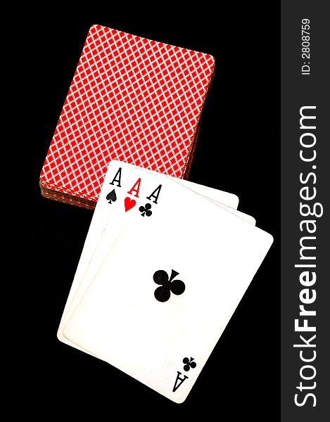 Three aces laid pn a deck of cards