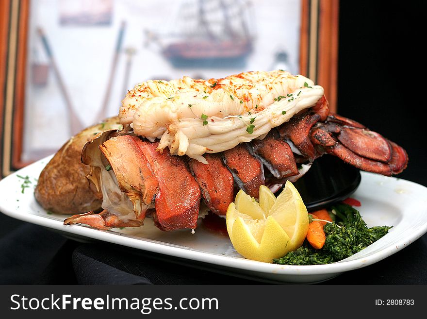 Broiled Lobster in front of a photo of a Lobster Boat and Traps. Broiled Lobster in front of a photo of a Lobster Boat and Traps