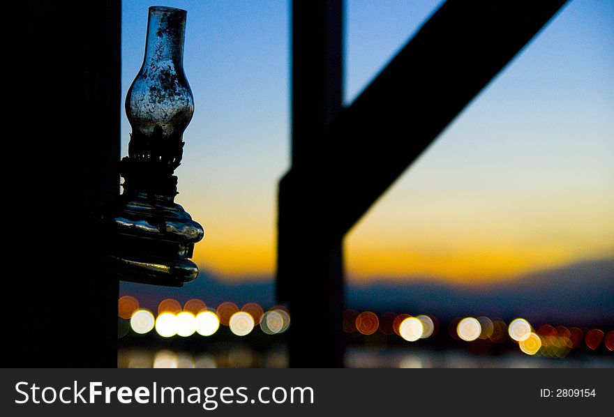 A solitude kerosene lamp hangs silently as the day changes from evening to dusk. A solitude kerosene lamp hangs silently as the day changes from evening to dusk