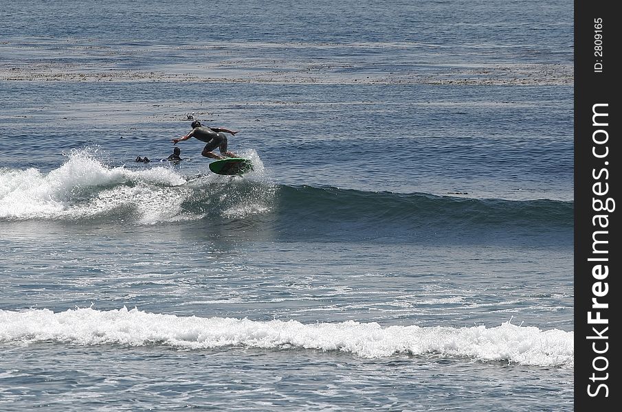 Surfer doing a 180 air. Surfer doing a 180 air