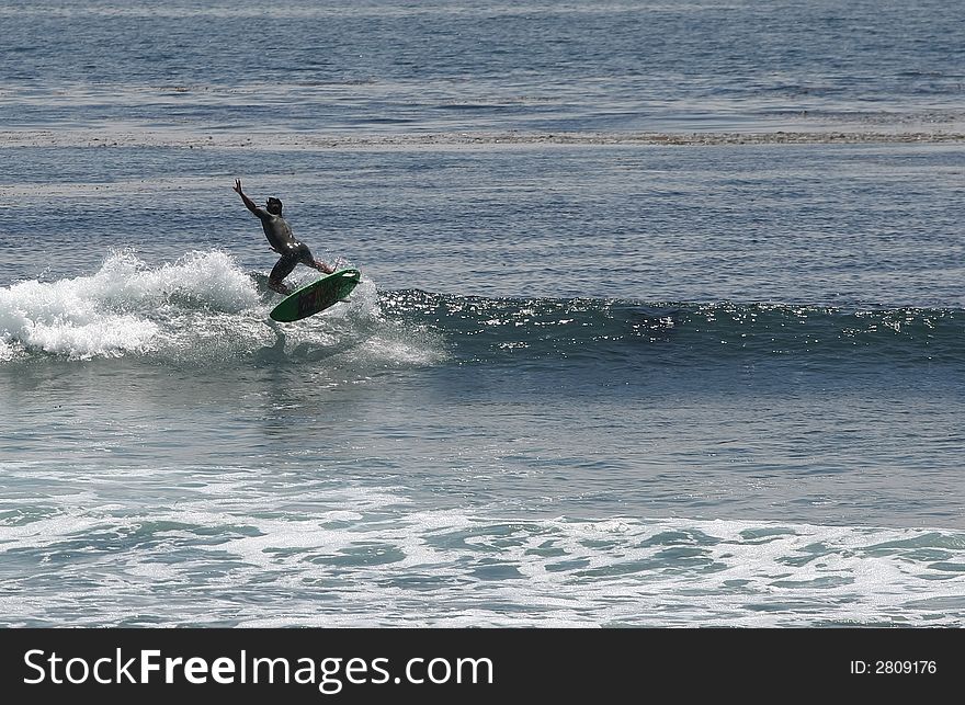 Surfer doing a 180 air. Surfer doing a 180 air