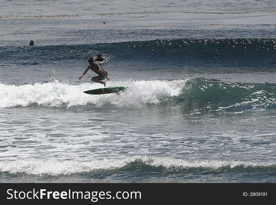 Surfer doing a 180 air. Surfer doing a 180 air