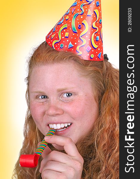 Birthday girl portrait with a party hat and wide smile over yellow background. Birthday girl portrait with a party hat and wide smile over yellow background