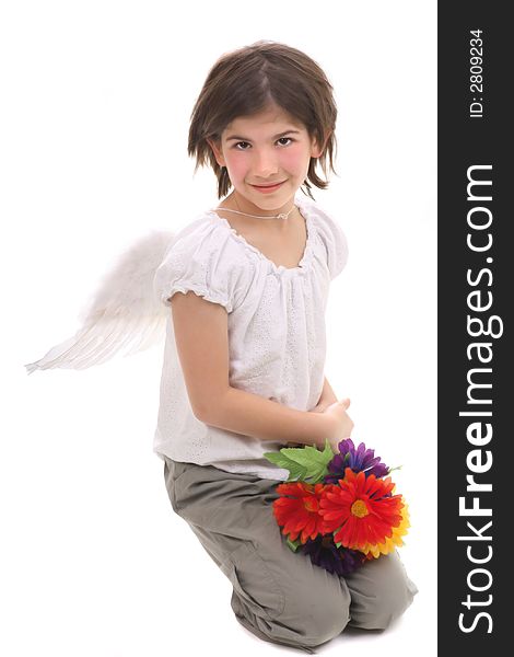 Angel girl with feather wings and flowers kneeling on white background. Angel girl with feather wings and flowers kneeling on white background