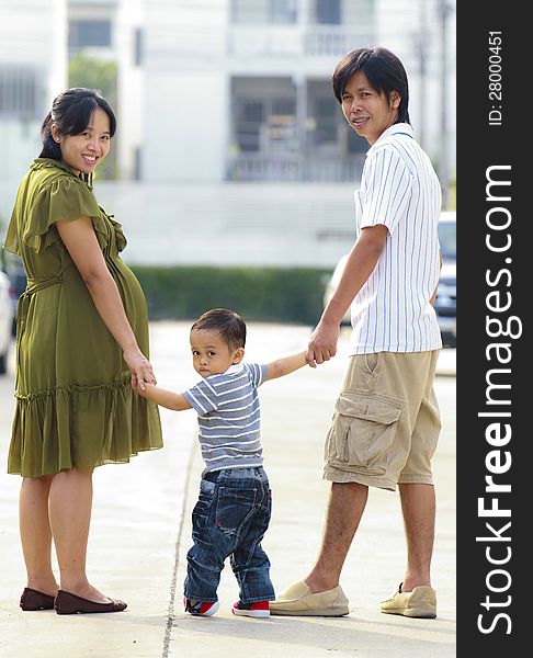 Parents holding hand of his son in outdoors