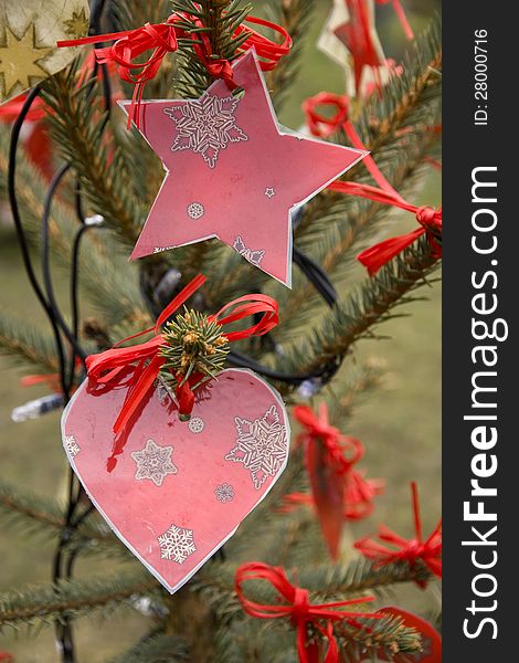 Detail of red hearts and stars on the christmas tree. Detail of red hearts and stars on the christmas tree
