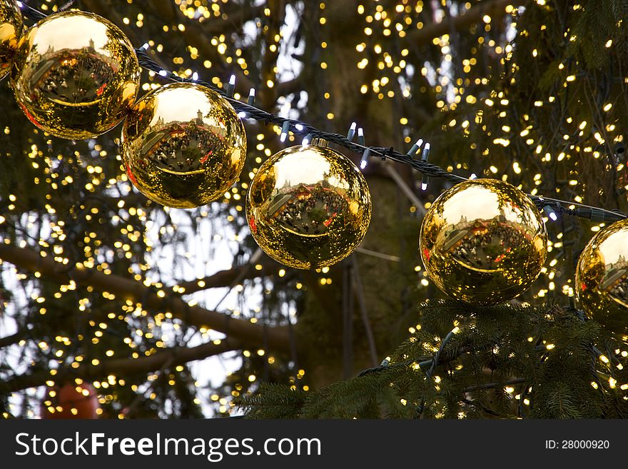 Golden christmas balls on the tree in a row