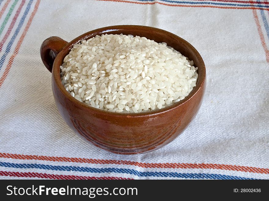 Dry white ovall rice in  ceramic mug. Dry white ovall rice in  ceramic mug