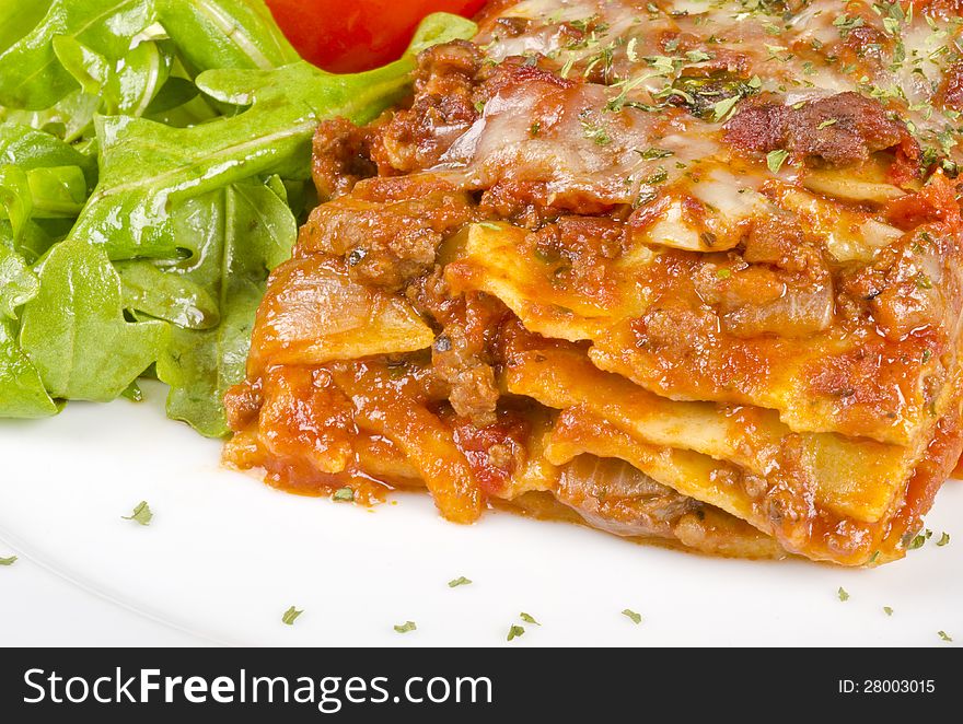 Closeup of a piece of meat lasagna and arugula salad #1. Closeup of a piece of meat lasagna and arugula salad #1.