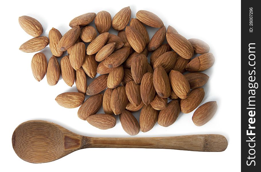 Almonds and wooden spoon isolated on white background