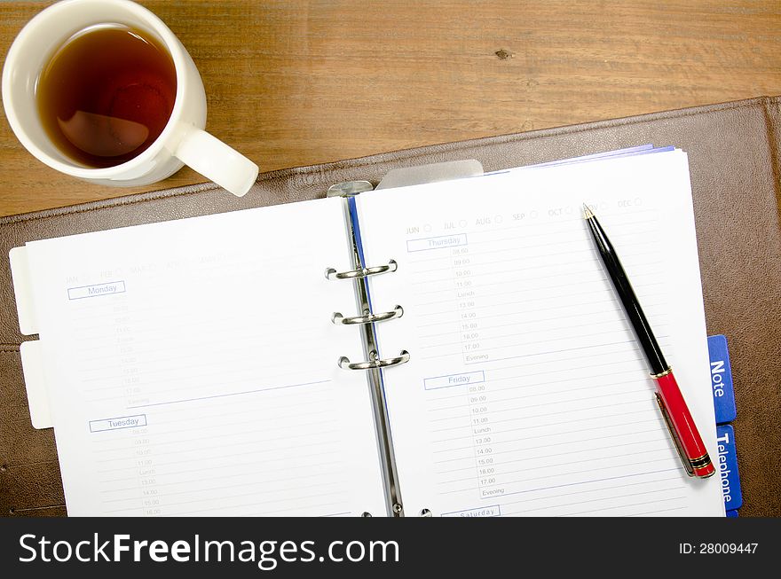 A cup of tea on notebook. A cup of tea on notebook