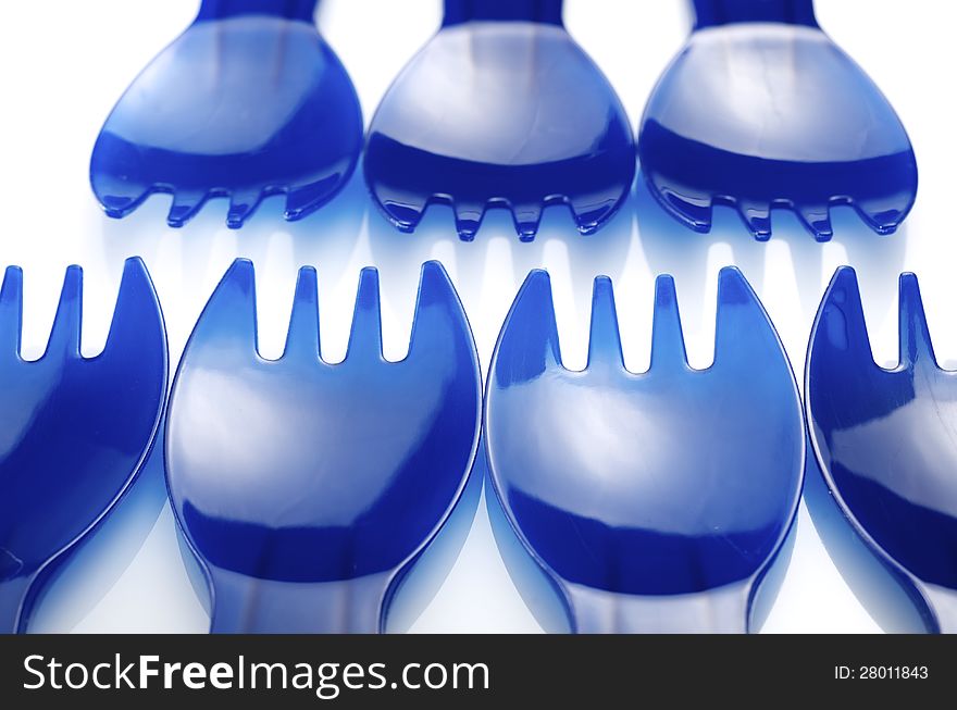 Disposable plastic forks on a white background