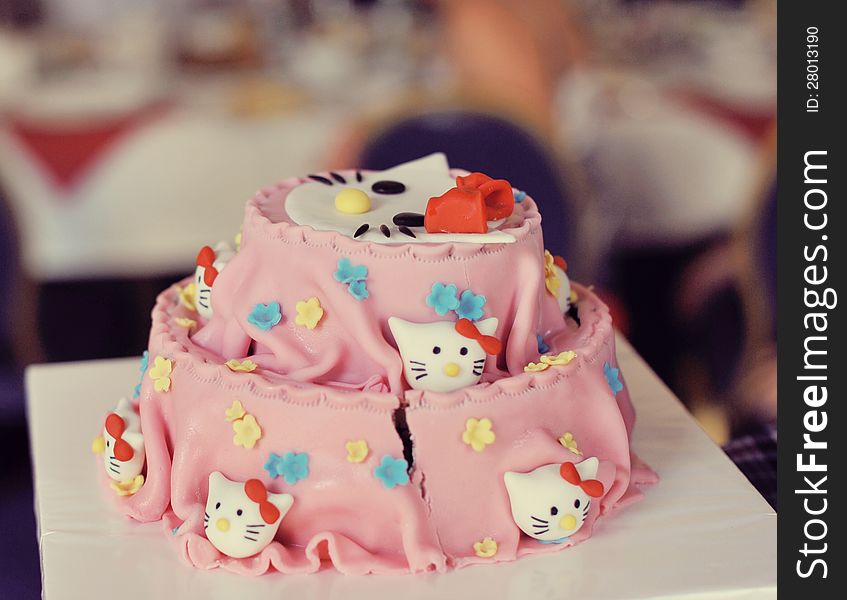 On a white background beautiful pink cake with muzzles cats. On a white background beautiful pink cake with muzzles cats