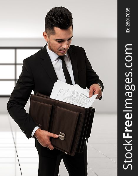 Businessman with a brown leather briefcase holding a contract  contract. Businessman with a brown leather briefcase holding a contract  contract