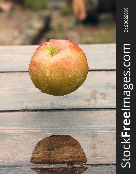 Ripe apple lying on a wooden table. Rural. Ripe apple lying on a wooden table. Rural.