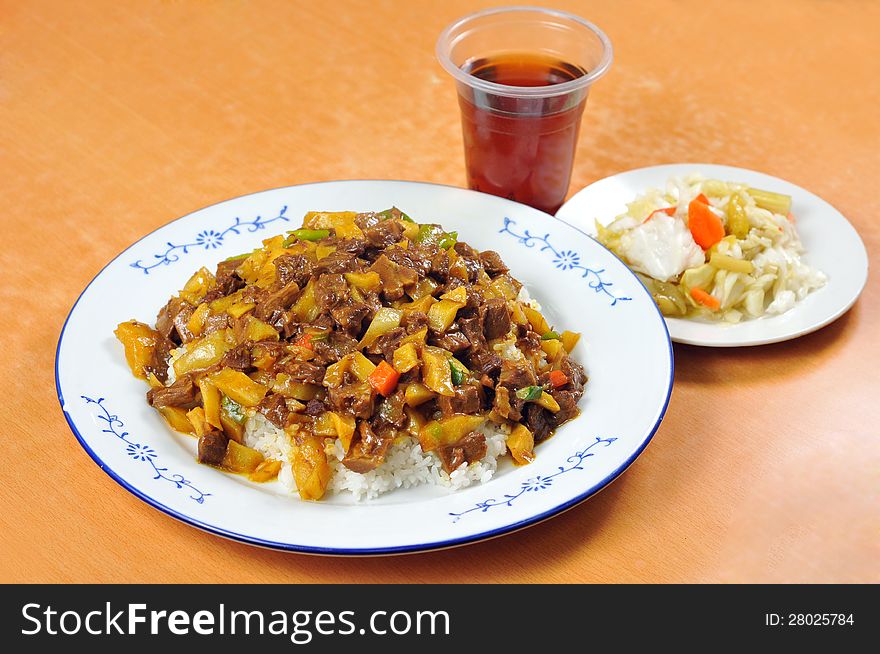 Chinese cuisine - beef, potatoes and rice, with vegetables, salad and soda