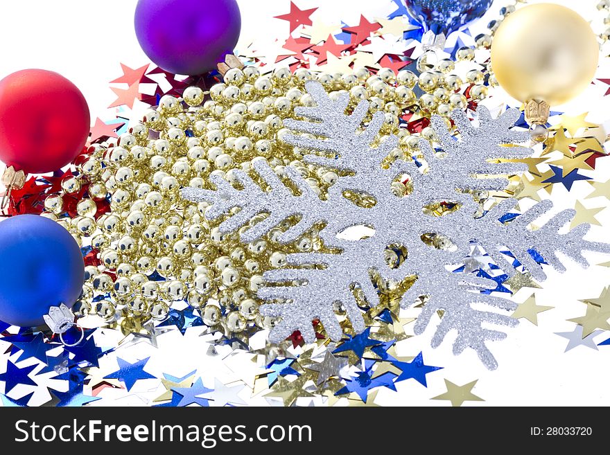 Christmas background includes: silver snowflake, star confetti and colorful christmas balls with a golden decorative chain. Isolated on white. Christmas background includes: silver snowflake, star confetti and colorful christmas balls with a golden decorative chain. Isolated on white.