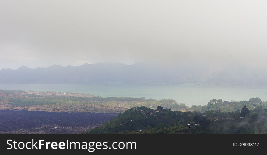 Foggy rural landscape with meadows a lake and mountains. Foggy rural landscape with meadows a lake and mountains