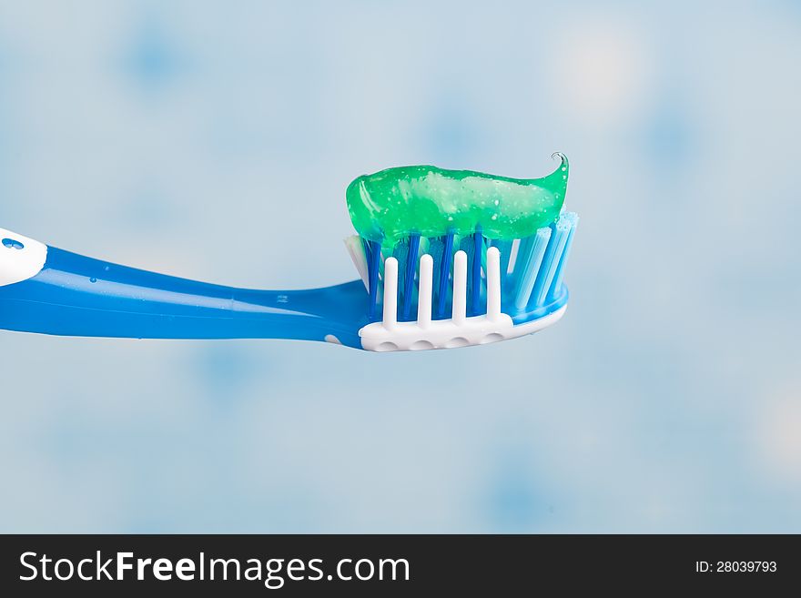 Toothbrush against blue tile background. Toothbrush against blue tile background