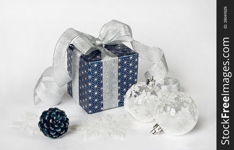 Gift box with christmas balls and snowflakes