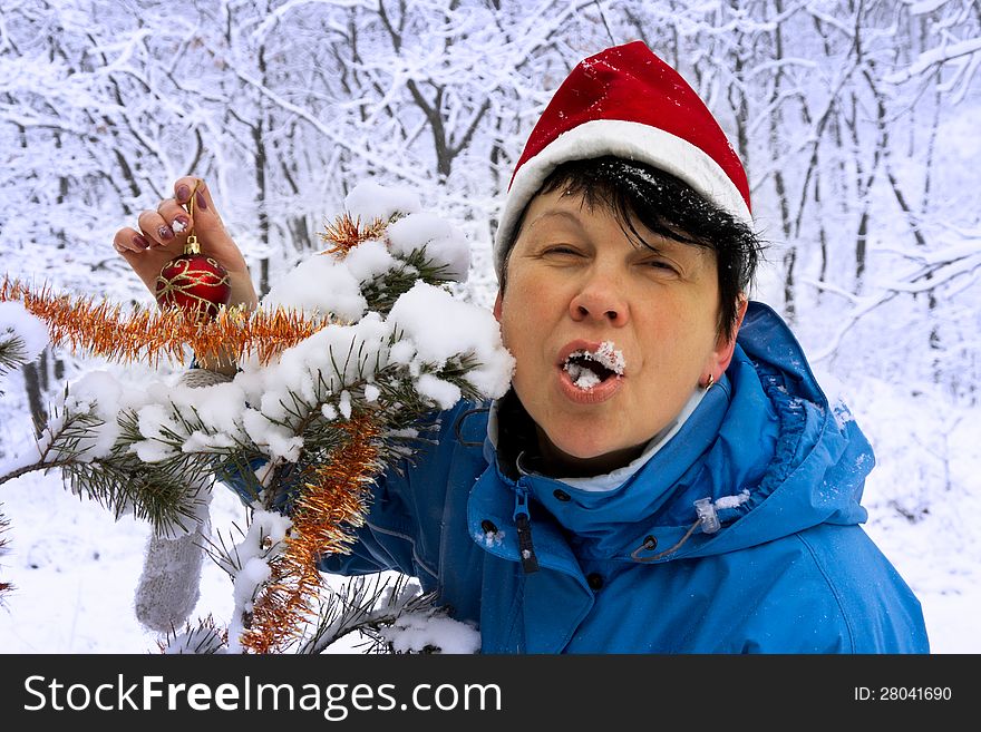 Cheerful woman with snow in the mouth. Cheerful woman with snow in the mouth