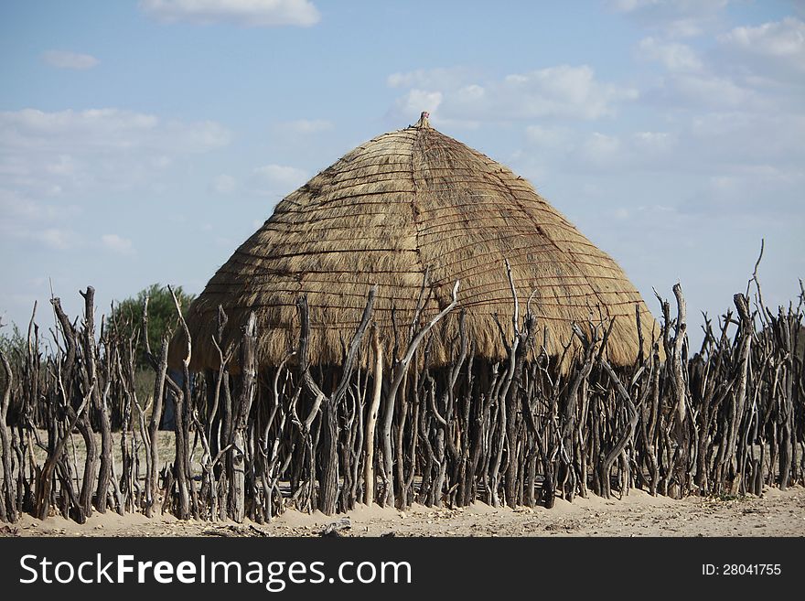 A photo of a bushmen hut in a native bsuhmen kraal in the Kalahari Desert where they live. Made of twigs and grass. A photo of a bushmen hut in a native bsuhmen kraal in the Kalahari Desert where they live. Made of twigs and grass.