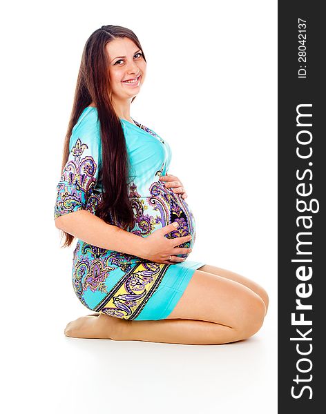 Pregnant girl sitting isolated on white background