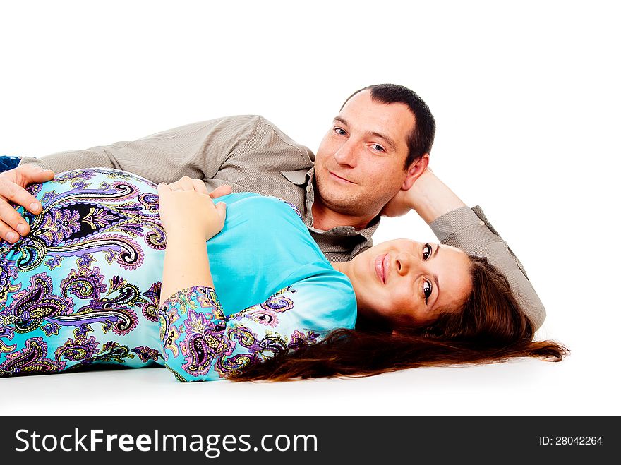 Husband lies next to the pregnant wife isolated on white background