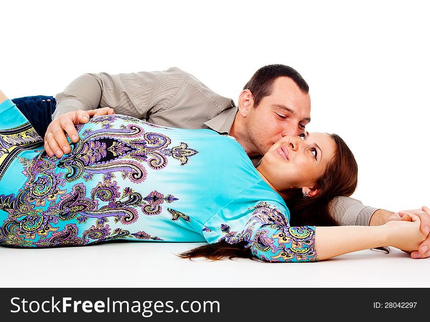 Husband lies next to the pregnant wife isolated on white background