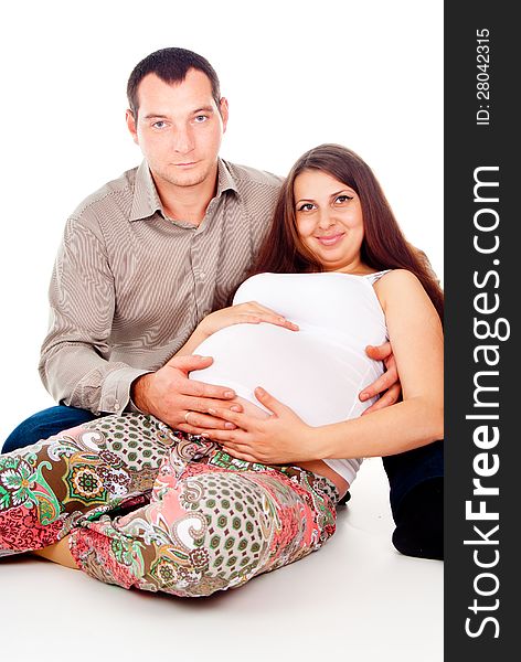 Husband hugs pregnant wife isolated on white background
