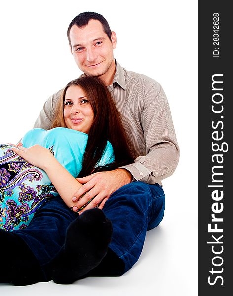 Dad hugs pregnant wife  on white background