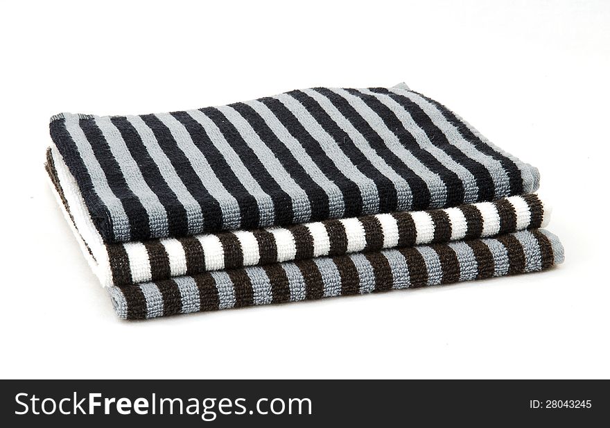 Stack of black and white striped towels isolated on white. Stack of black and white striped towels isolated on white