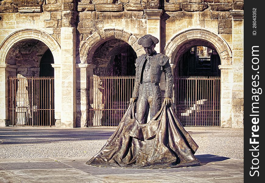 Roman Coliseum with a statue of a bullfighter- Nimes, France. Roman Coliseum with a statue of a bullfighter- Nimes, France