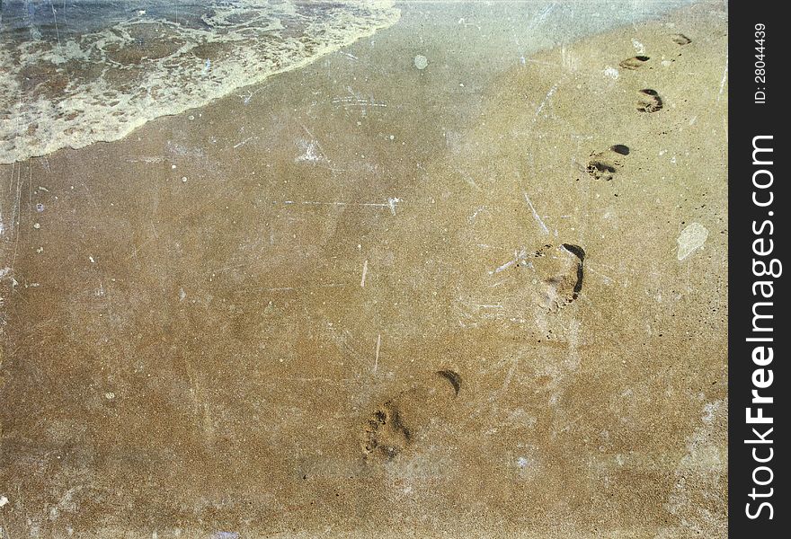 Vintage photo of footsteps in sand