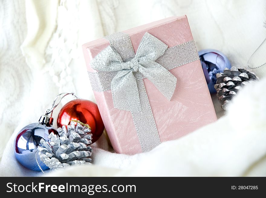Gift box put on white clothing with christmas ornament. Gift box put on white clothing with christmas ornament