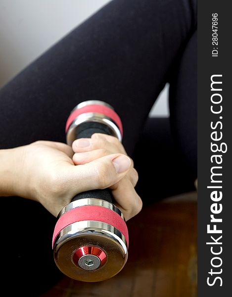 Sporty woman is working out with dumbbell. Sporty woman is working out with dumbbell