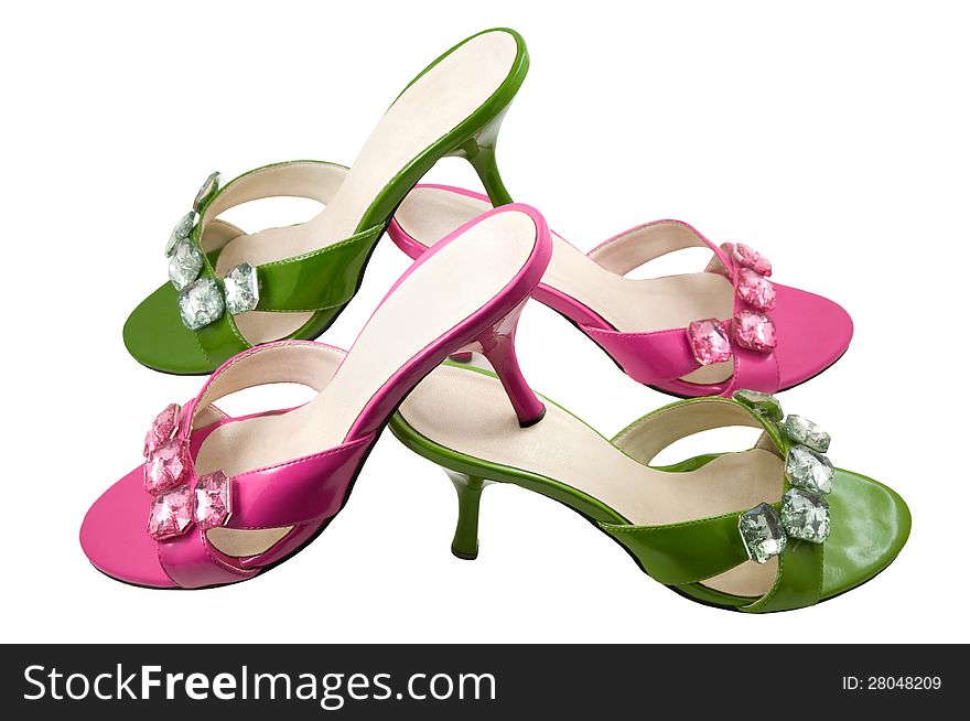 Two pairs pink and green shoes are photographed on a white background